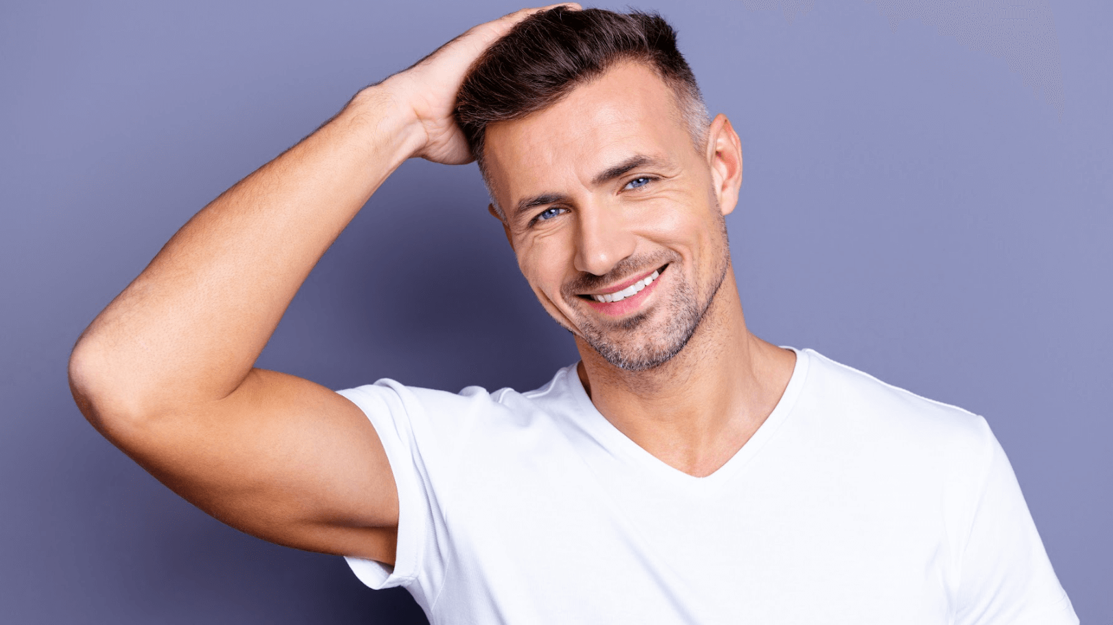 man holding head and smiling